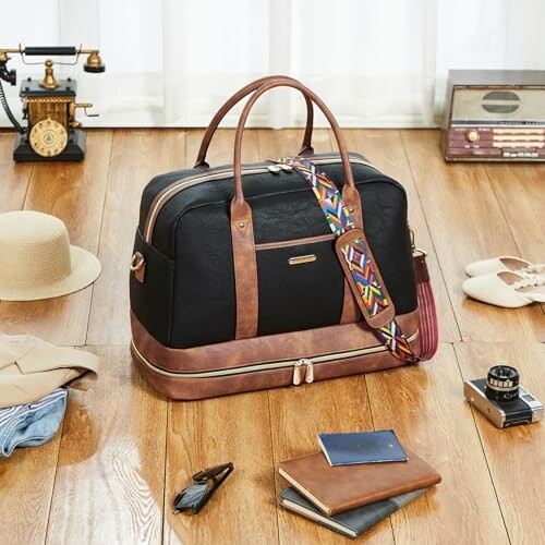Vintage-style travel duffle bag with accessories on wooden floor.
